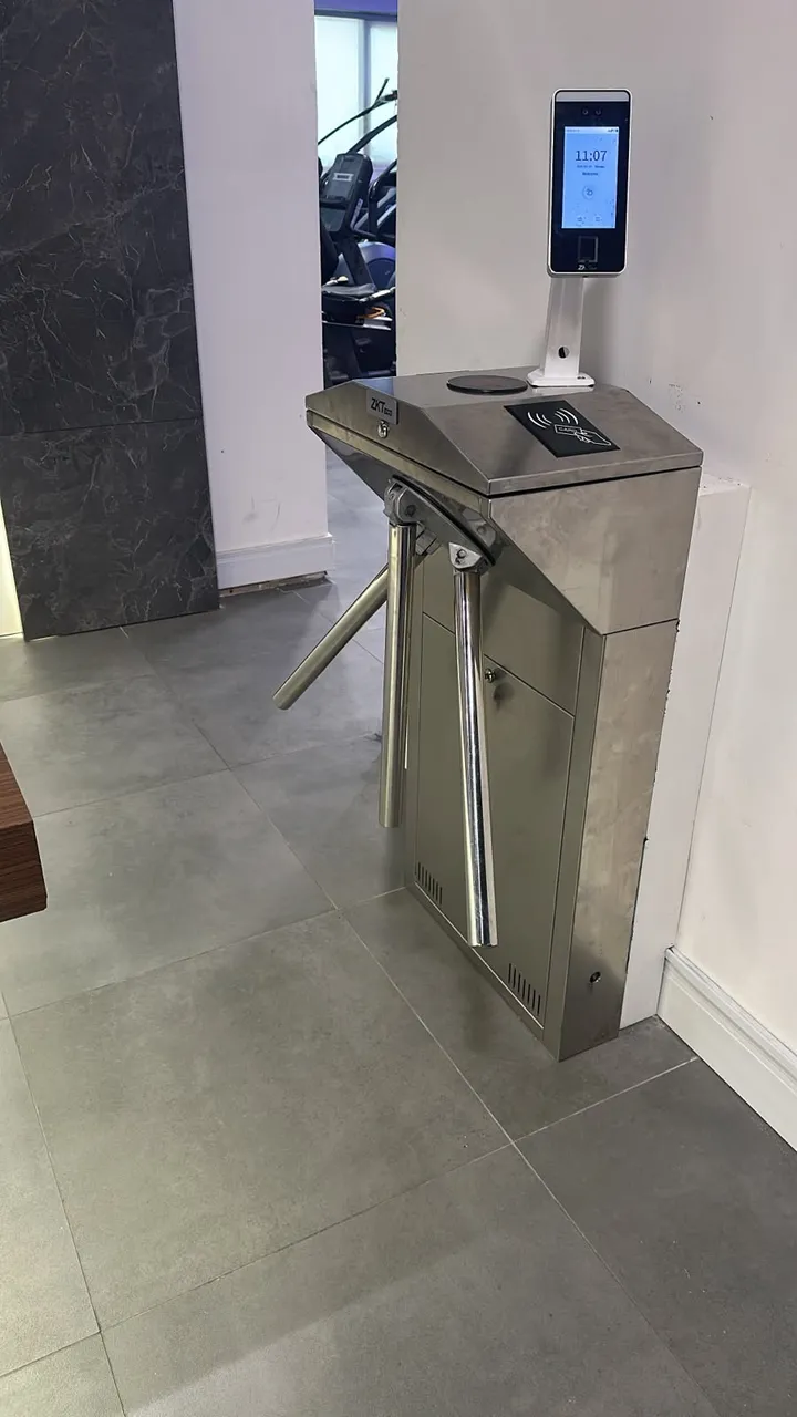 ZKTeco tripod turnstile with face recognition terminal at a gym entrance